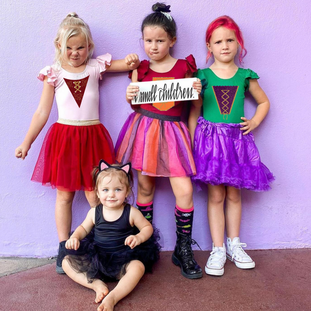 All three Hocus Pocus inspired witches in short ruffle sleeve leotards as well as a black tank leotard on a smaller child used as a cat costume.