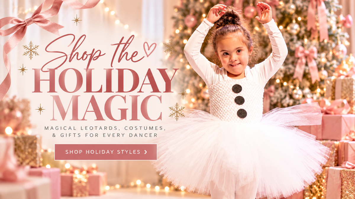 A young girl in a white holiday costume with black buttons and a white tutu stands in a festive Christmas tree and gift setting, with large promotional text reading 'Shop the HOLIDAY MAGIC' and smaller text about magical legoards, costumes, and gifts for every dancer.