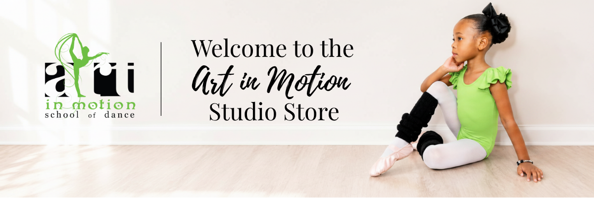 A young girl dancer sits on a light wood floor wearing a bright green leotard and white tights, with black leg sleeves. The background is a white wall with the text 'Welcome to the Art in Motion Studio Store' and the Art in Motion logo.